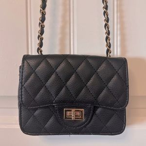 Black quilted crossbody purse with gold tone chain